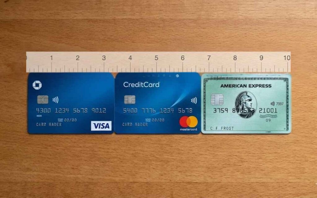 Three credit cards—a Visa, a Mastercard, and an American Express—lined up horizontally. A ruler placed above them shows their combined width is exactly 10 inches.